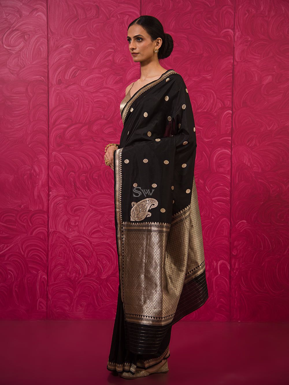 black pure katan silk saree. paired with ivory embroidered cowl top with  embroidered velvet tie-knot belt Design by Neha & Tarun at Modvey